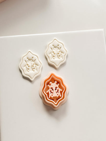 Lucky Lady Polymer Clay Cutter: Embossed Ladybug in Wavy Frame