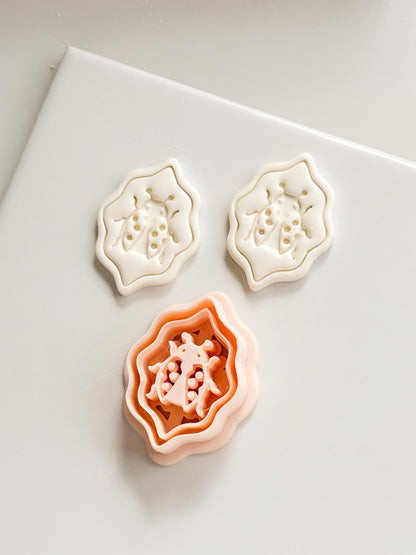 Lucky Lady Polymer Clay Cutter: Embossed Ladybug in Wavy Frame